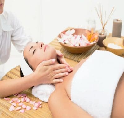 Female receiving light aromatherapy massage to neck area