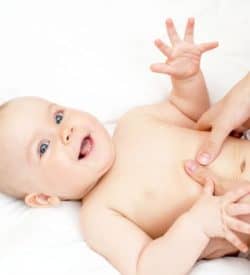 Giggling baby receiving baby massage during Bali BISA maternity care program