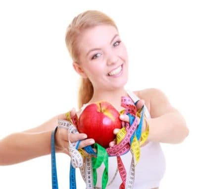 Slimming Massage course at Bali BISA. Pictures is a woman holding apple and measuring tapes so checking the success of slimming massage