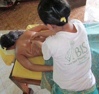 Bali BISA trainer showing muscles on the back to students
