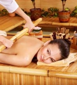 Young woman getting bamboo massage.