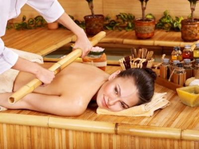 Young woman getting bamboo massage.