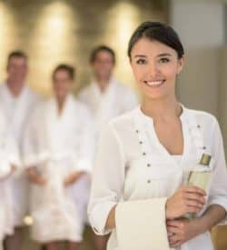 confident-women-smile-with-spa-client-behind