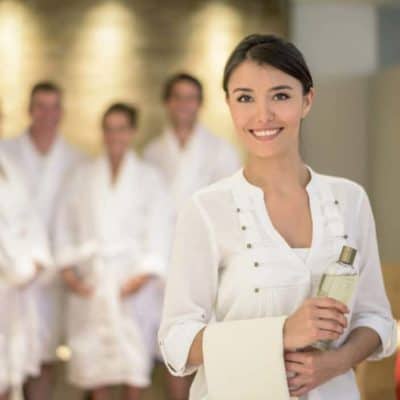 confident-women-smile-with-spa-client-behind